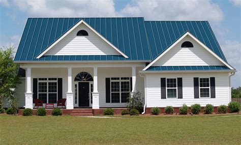 white house with blue metal roof|blue siding with white shutters.